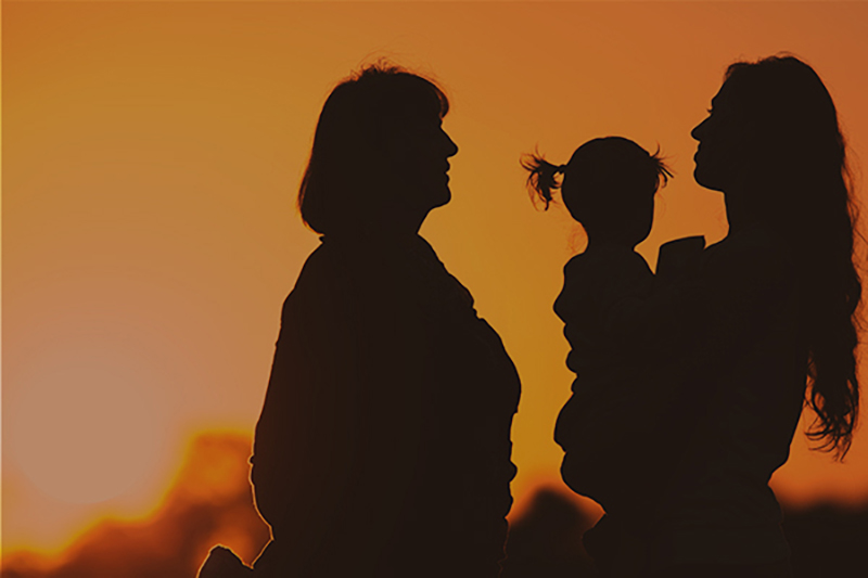 Silhouette of happy family with mother, daughter and grandmother outdoor. Fall season. Healthy concept. Mothercare is most important in baby life. Silhouete adults